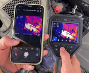 A person is conducting infrared training with a HIKMICRO M30 camera in front of a car. A person is conducting infrared training with a HIKMICRO M30 camera in front of a car.